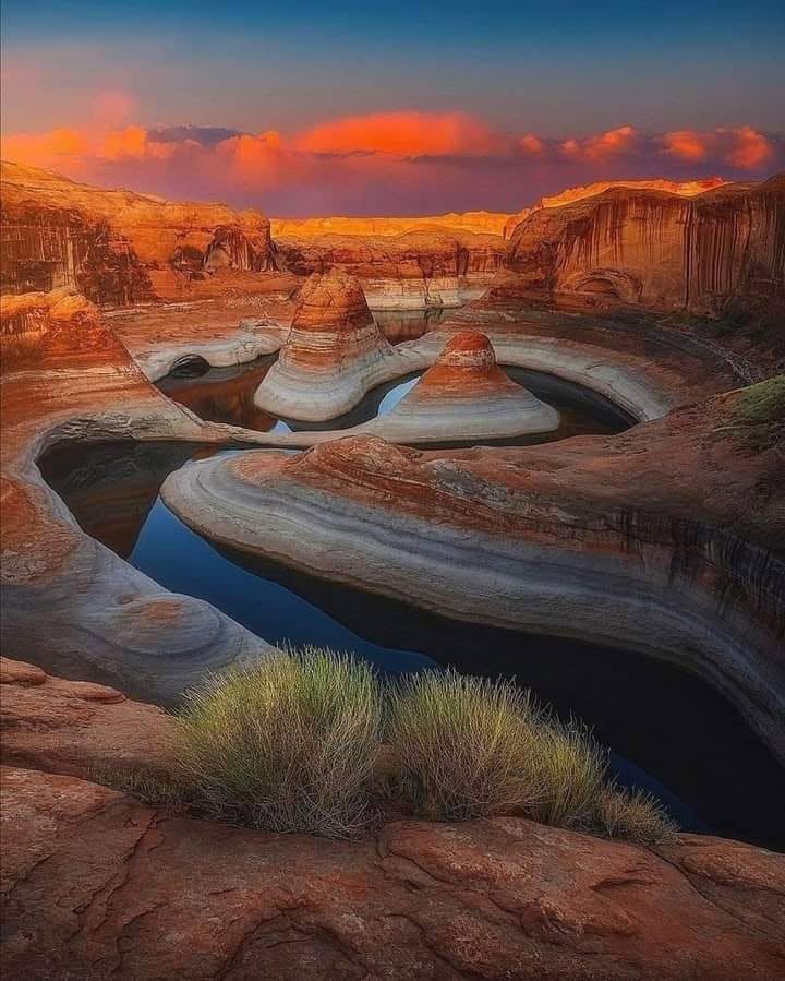 A winding canyon at sunset, water threading between the rock